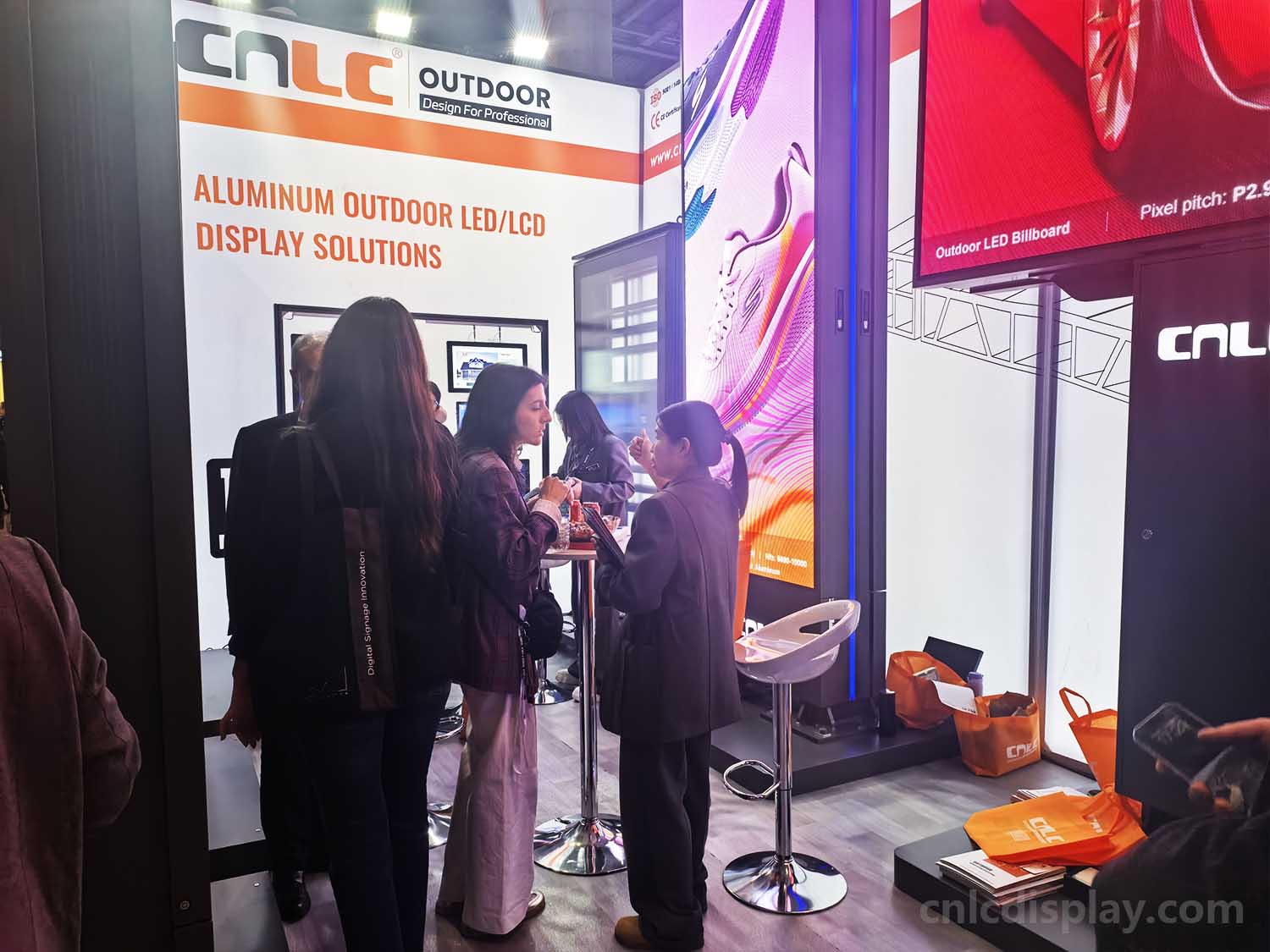 Customer experiencing CNLC outdoor fine-pitch LED MUPI at ISE 2026 booth.