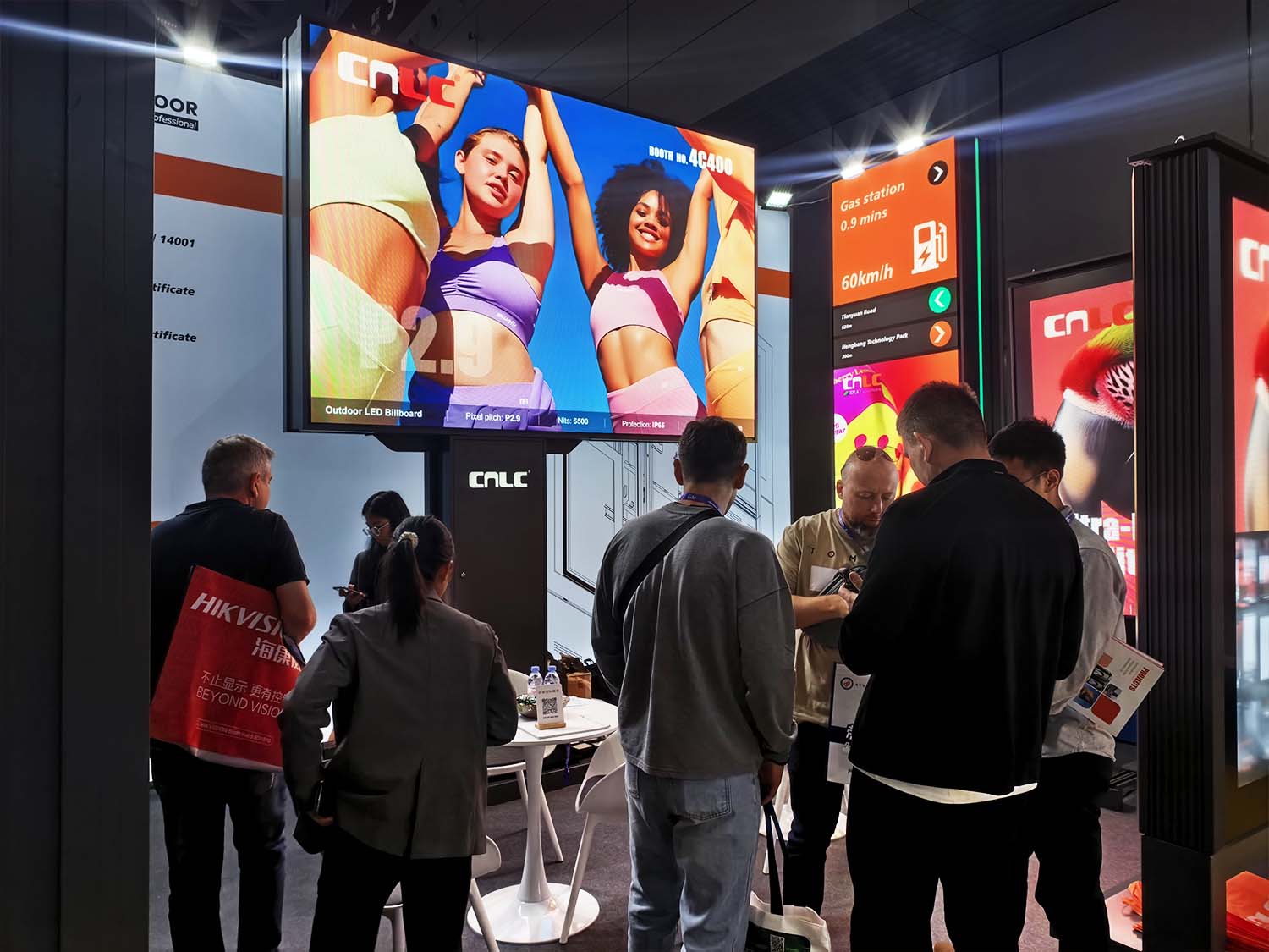 Industry professionals discussing outdoor digital signage solutions at CNLC booth